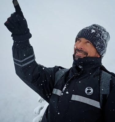 a man in a black jacket and a hat
